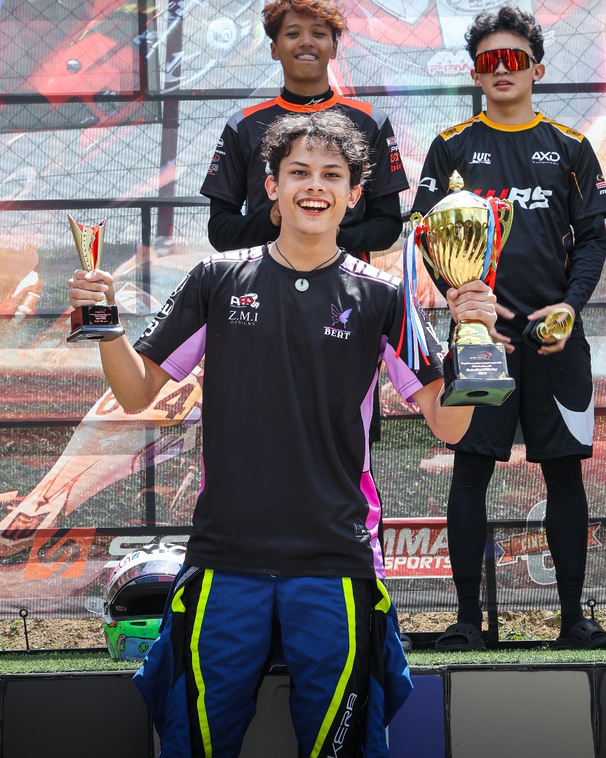Zack holding trophies